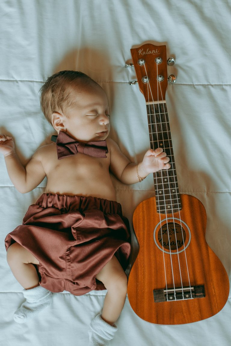 Baby and guitar together. What is the difference between recorded vs live music therapy for premature babies?