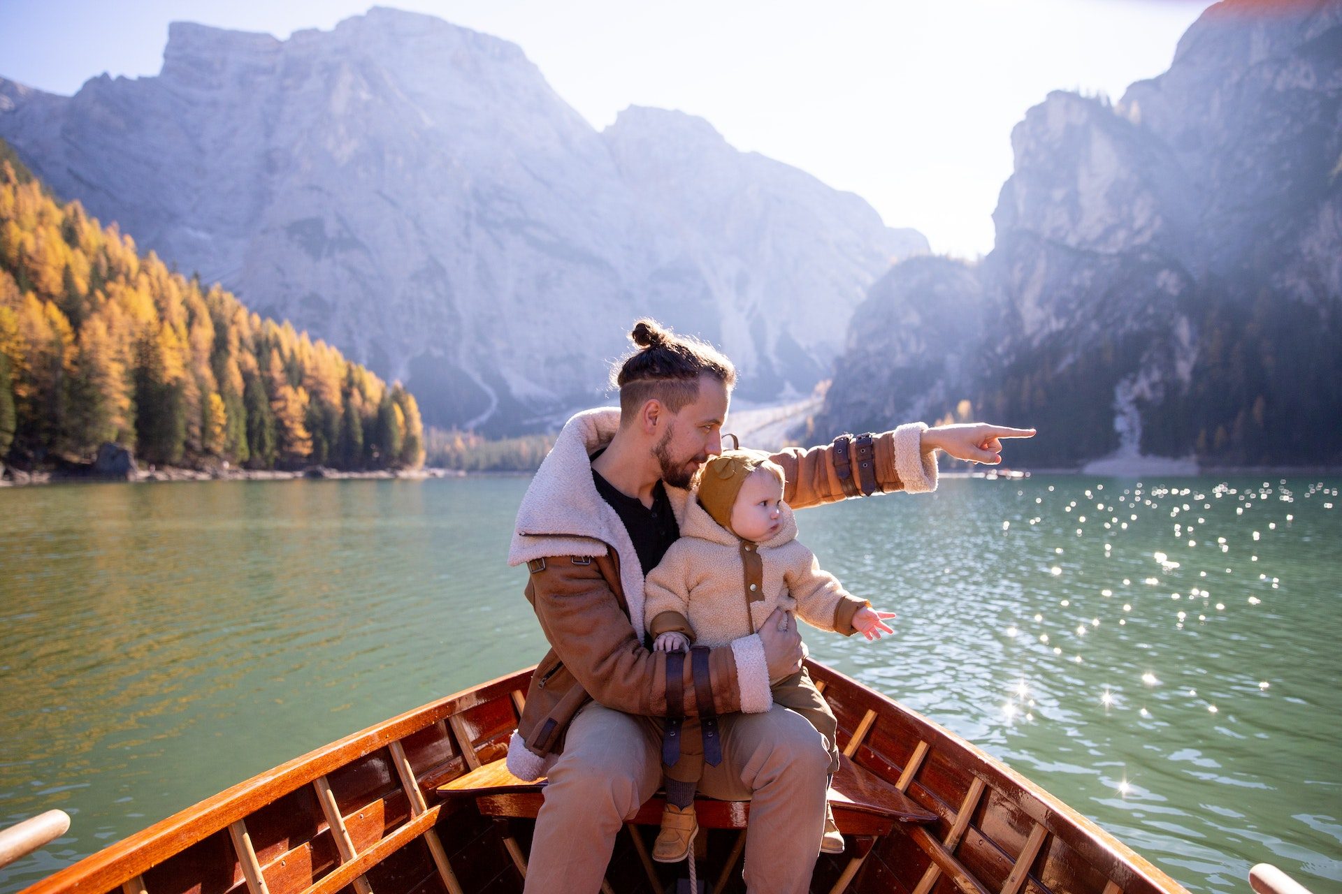 Father and his baby daughter, in a boat on a lake. FAQ about baby music.
